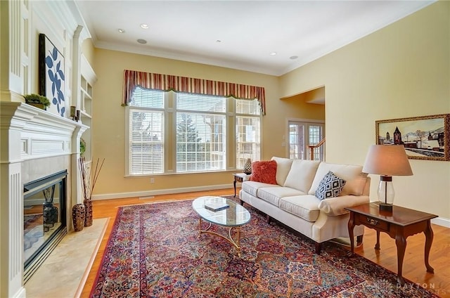 living area featuring a fireplace, light wood-type flooring, and a wealth of natural light