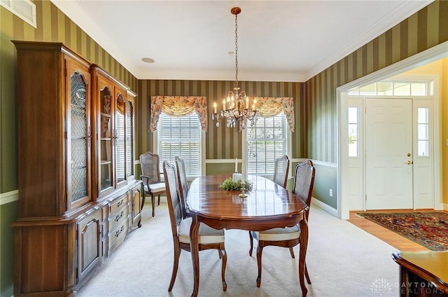 dining space featuring wallpapered walls, an inviting chandelier, baseboards, and light carpet