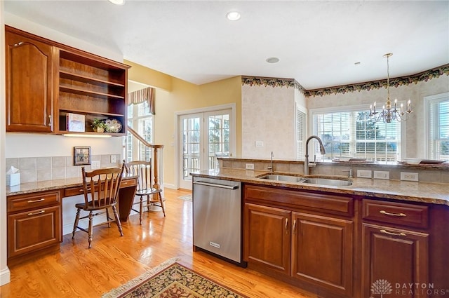 kitchen with light wood-style flooring, a sink, open shelves, stainless steel dishwasher, and built in study area