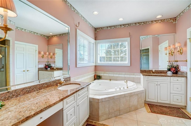 full bathroom featuring tile patterned flooring, a shower stall, a jetted tub, and a sink