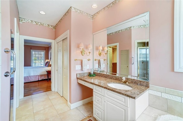 ensuite bathroom featuring vanity, baseboards, ensuite bath, recessed lighting, and tile patterned flooring