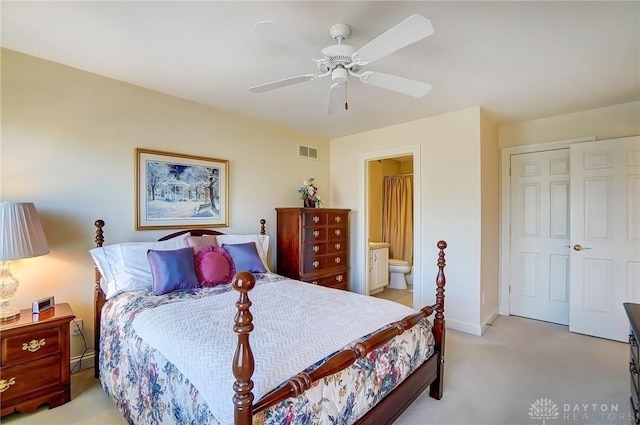 bedroom featuring visible vents, connected bathroom, baseboards, ceiling fan, and light carpet