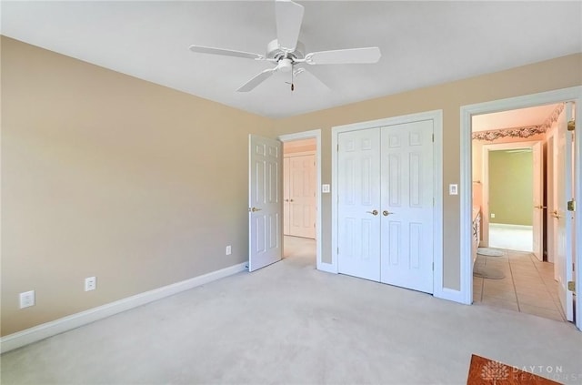 unfurnished bedroom with a ceiling fan, baseboards, a closet, and carpet floors