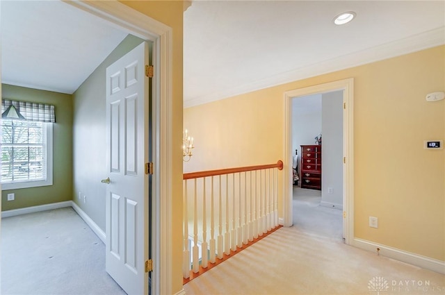 corridor with a notable chandelier, recessed lighting, baseboards, and carpet