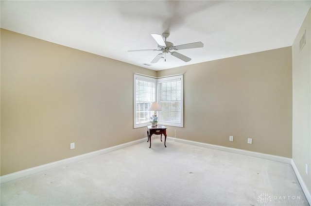 carpeted empty room featuring visible vents, baseboards, and ceiling fan