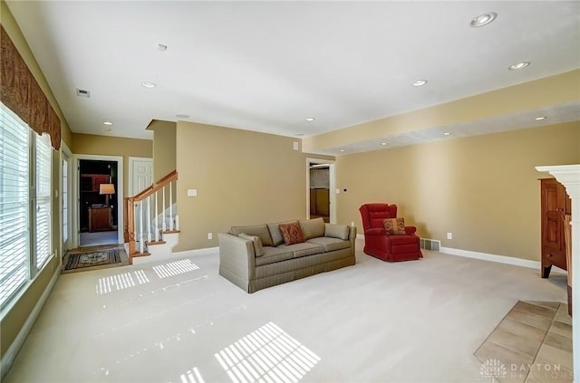 carpeted living room with stairway, recessed lighting, visible vents, and baseboards