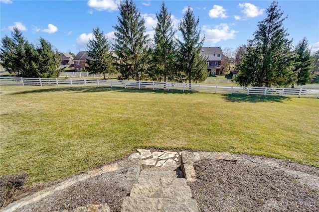 view of yard with a rural view and fence