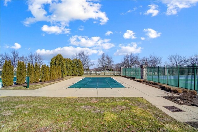 view of pool with a fenced in pool, a lawn, and fence