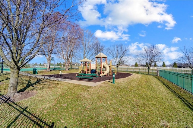 communal playground with a lawn and fence