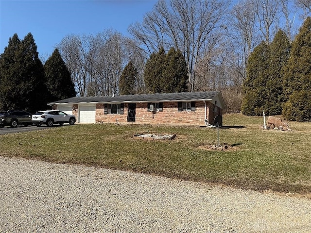 ranch-style house featuring brick siding, an attached garage, driveway, and a front yard