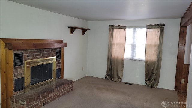 unfurnished living room featuring visible vents, carpet flooring, and a fireplace