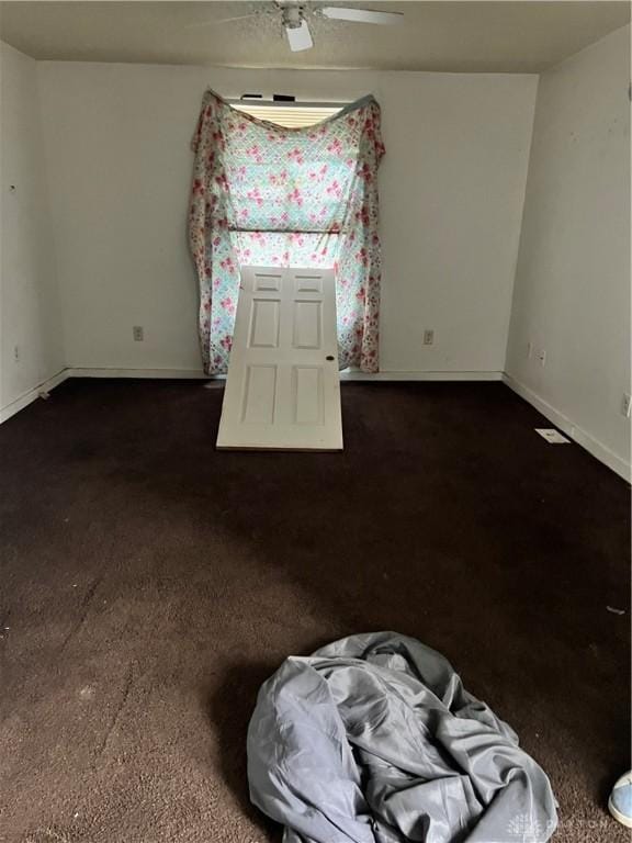 unfurnished room with baseboards and ceiling fan