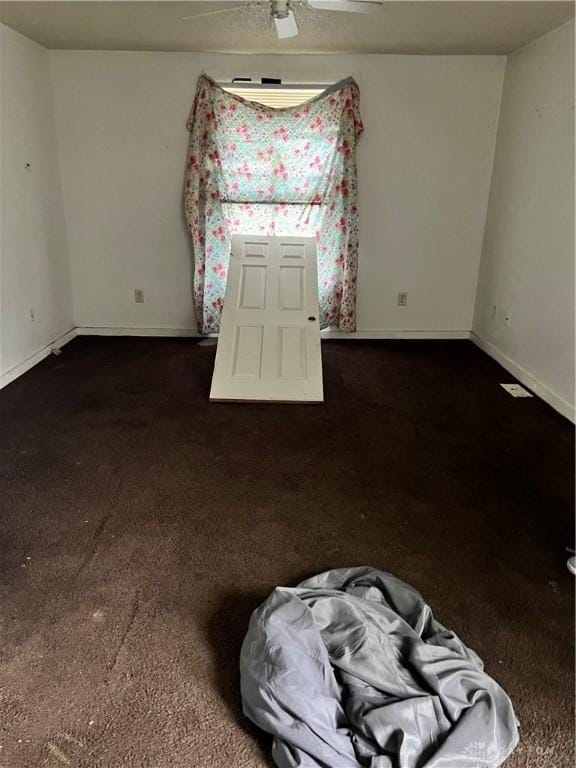 spare room with baseboards