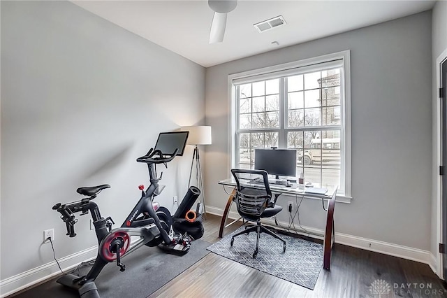 office space featuring visible vents, ceiling fan, baseboards, and wood finished floors