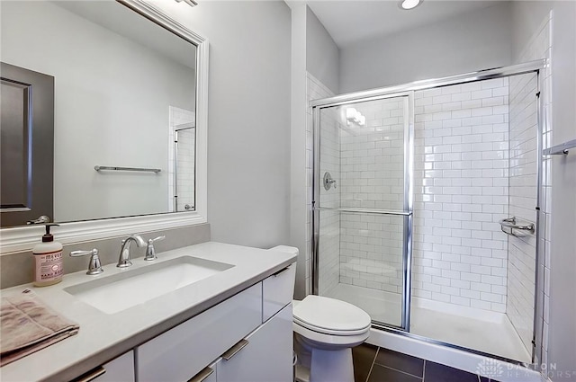 full bathroom featuring tile patterned flooring, toilet, vanity, and a stall shower