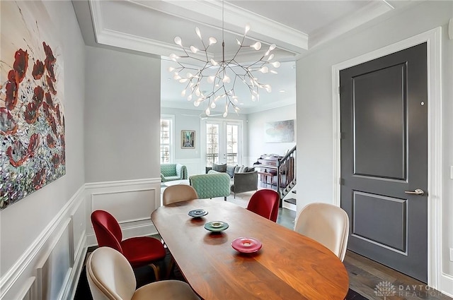 dining room featuring stairs, french doors, a wainscoted wall, and ornamental molding