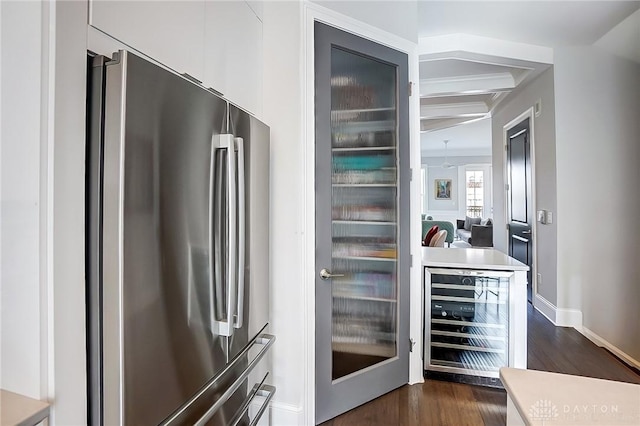 kitchen featuring dark wood-style flooring, freestanding refrigerator, wine cooler, white cabinets, and modern cabinets