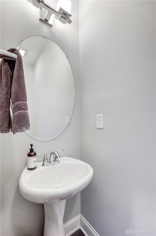 bathroom featuring baseboards and a sink