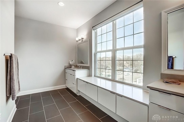 bathroom featuring recessed lighting, vanity, and baseboards