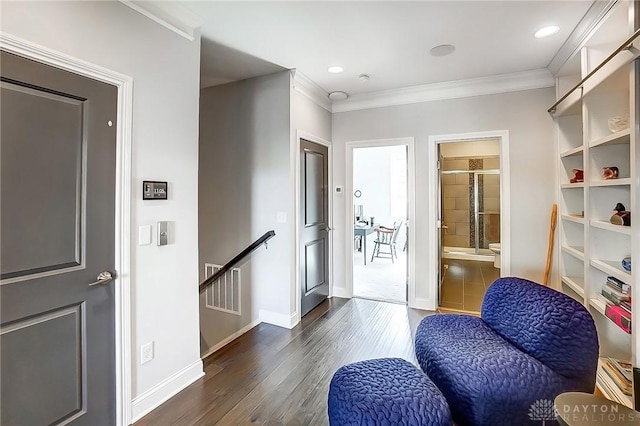 interior space featuring an upstairs landing, dark wood-style floors, crown molding, and baseboards