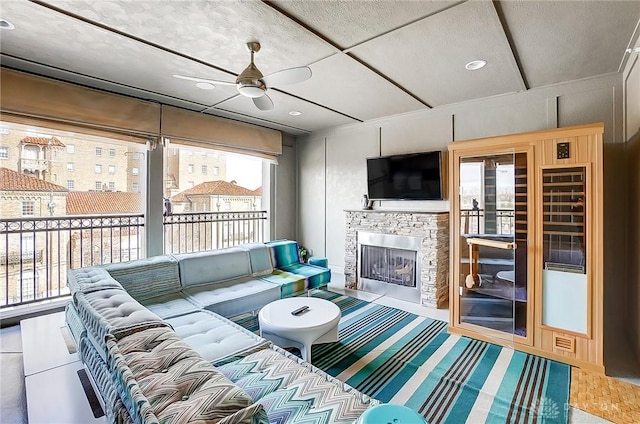 living room featuring a fireplace with flush hearth, recessed lighting, and ceiling fan