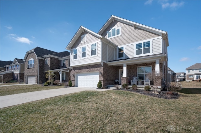 view of front of home with concrete driveway, covered porch, brick siding, and a front yard