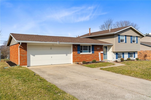 tri-level home with brick siding, a garage, driveway, and a front lawn