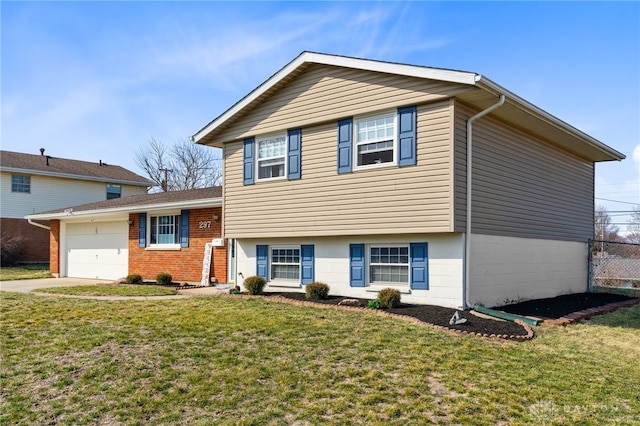 split level home featuring brick siding, driveway, an attached garage, and a front lawn