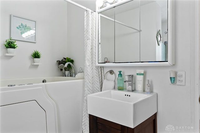 full bath featuring vanity and a bathing tub