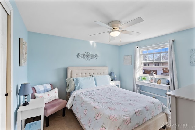 bedroom with a ceiling fan and carpet