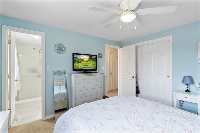 bedroom with light carpet, a ceiling fan, a closet, connected bathroom, and baseboards