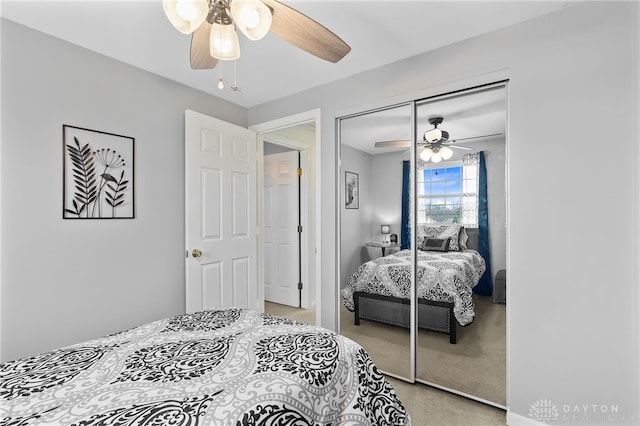 bedroom featuring a ceiling fan, a closet, and light carpet