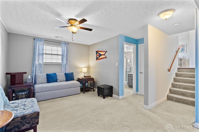 living room with baseboards, visible vents, carpet floors, stairs, and a textured ceiling