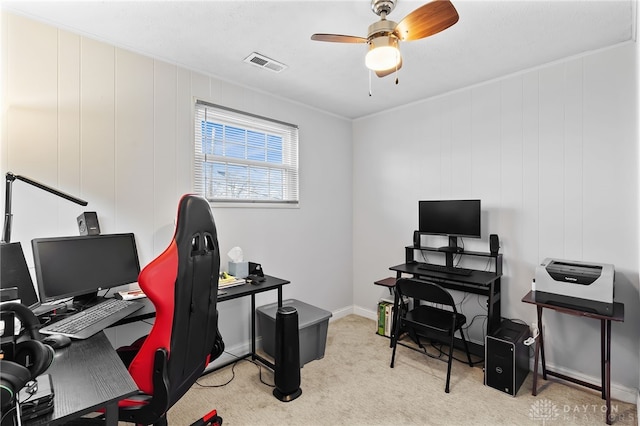 office area with visible vents, baseboards, light colored carpet, and ceiling fan