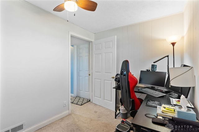 office area with visible vents, baseboards, ceiling fan, and carpet flooring