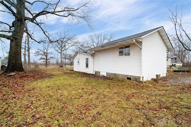 view of side of property with a lawn