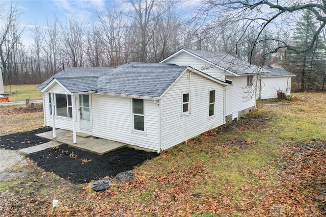 view of property exterior with roof with shingles