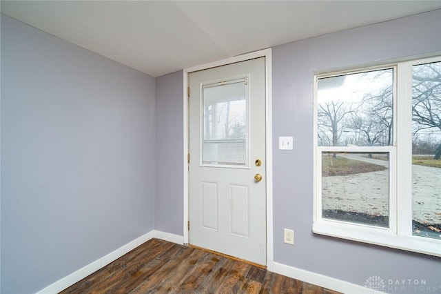 entryway with baseboards and dark wood finished floors