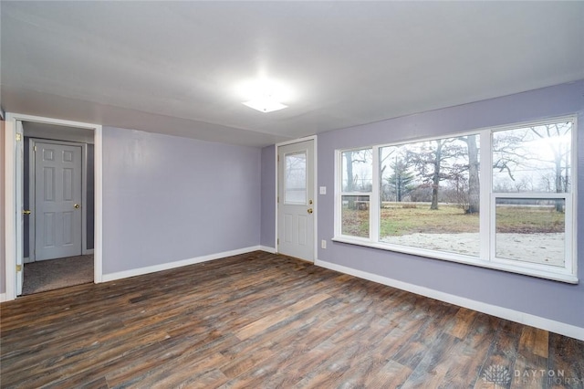 empty room with wood finished floors and baseboards