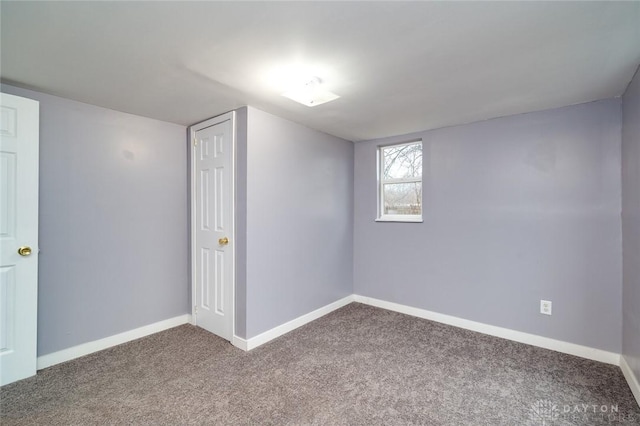 interior space featuring carpet and baseboards