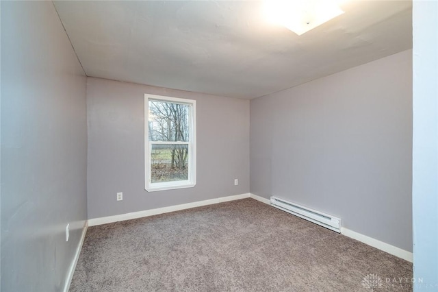 carpeted empty room with baseboards and a baseboard radiator