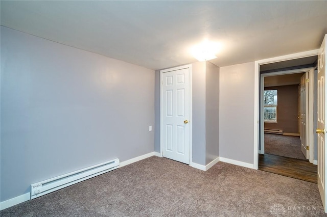 unfurnished bedroom with baseboards, baseboard heating, and carpet floors