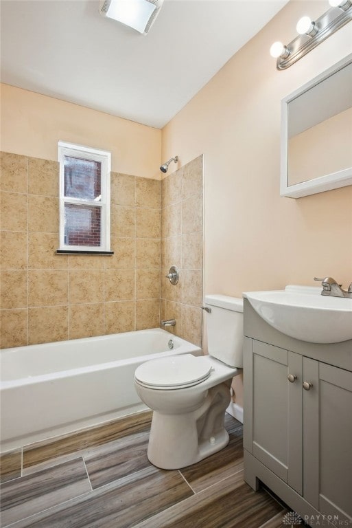 bathroom featuring vanity, shower / bath combination, toilet, and wood finish floors