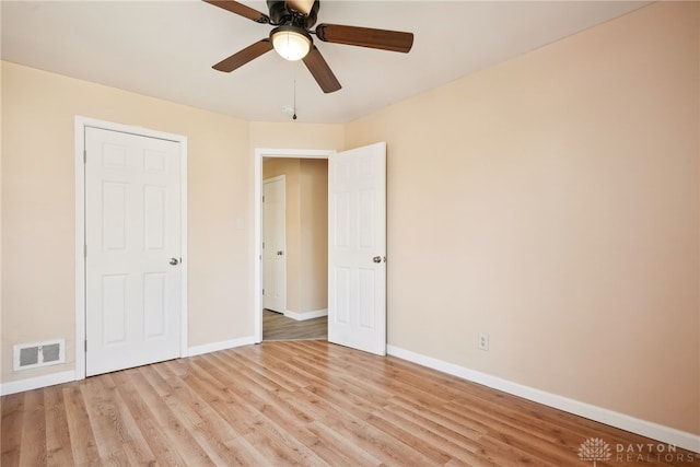 unfurnished bedroom with visible vents, baseboards, and light wood-style floors