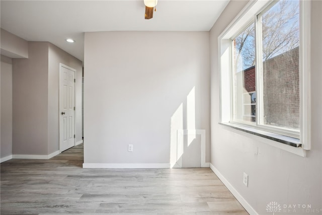 empty room featuring recessed lighting, baseboards, wood finished floors, and a ceiling fan