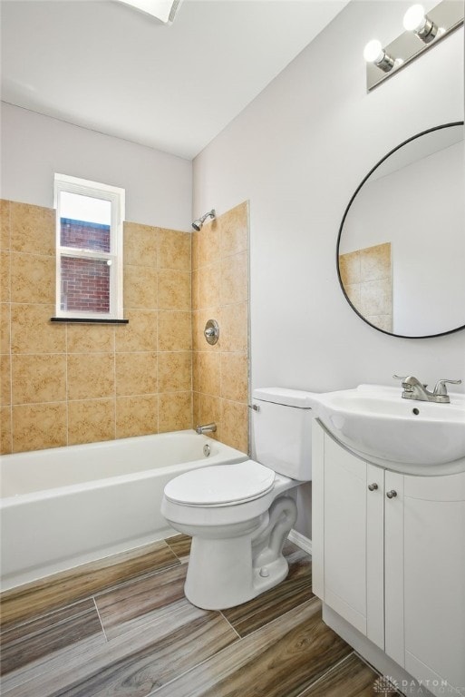 full bathroom featuring shower / bath combination, toilet, vanity, and wood finish floors