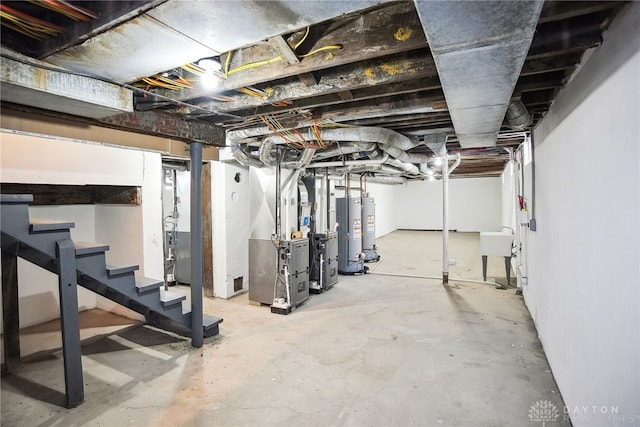 unfinished below grade area featuring a sink, stairway, heating unit, and water heater