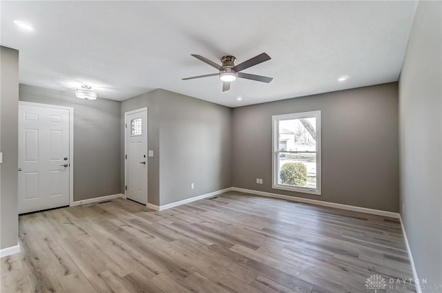 foyer featuring ceiling fan, baseboards, and wood finished floors