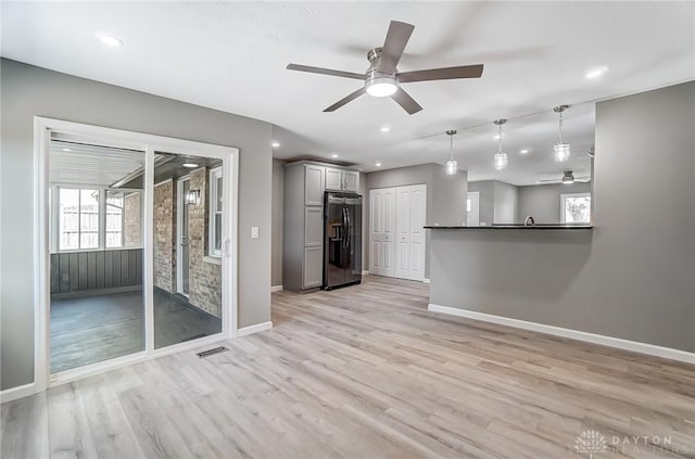 unfurnished living room featuring recessed lighting, visible vents, light wood-style flooring, and baseboards