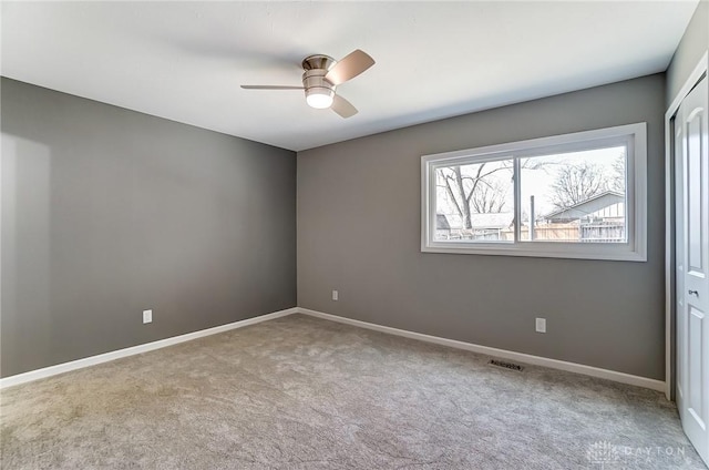 unfurnished bedroom featuring visible vents, ceiling fan, baseboards, carpet floors, and a closet